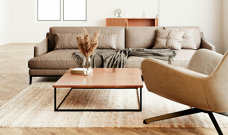 Open-concept apartment living room with neutral décor, sofa, and coffee table arrangement