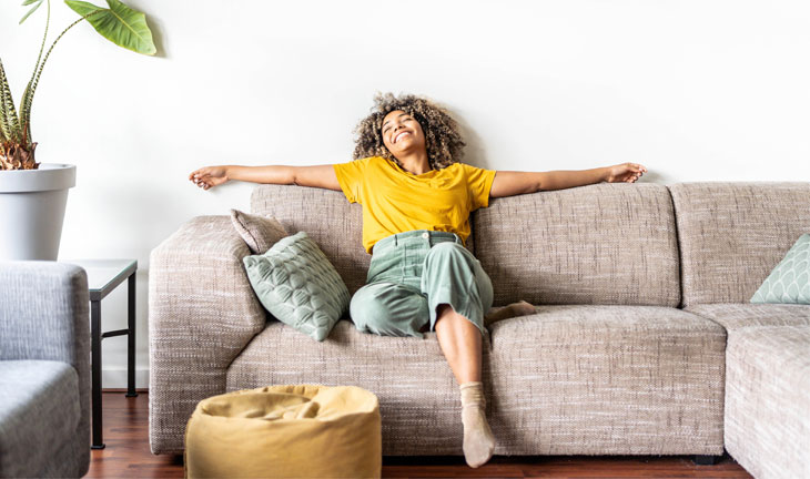 Renter relaxing on a comfortable sofa in a modern apartment