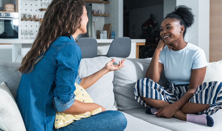 Roommates chatting together in a shared apartment living room
